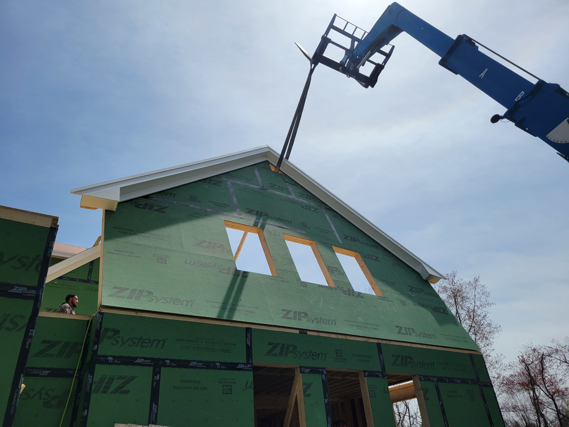 Telehandler assisting in gable flip in Concord.