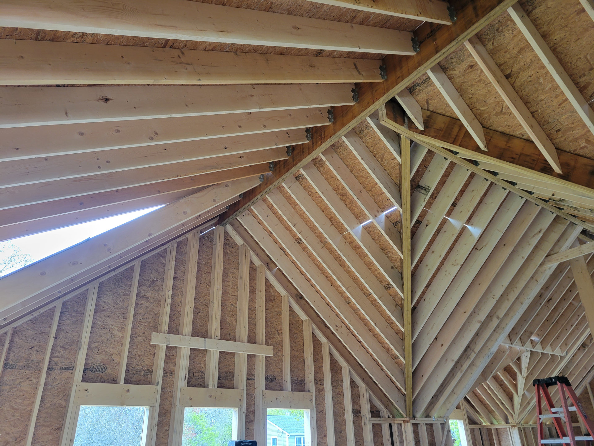 Double-valley, offset ridge, gable roof frame for Concord residence.