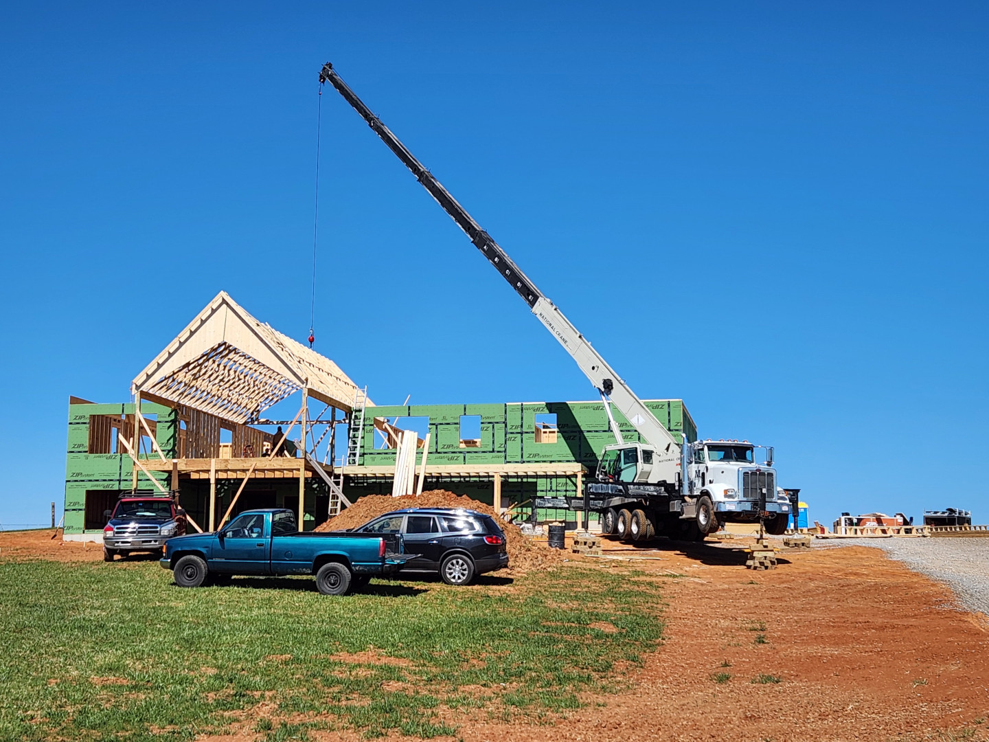 Crane moving trusses during roof install in Limestone.